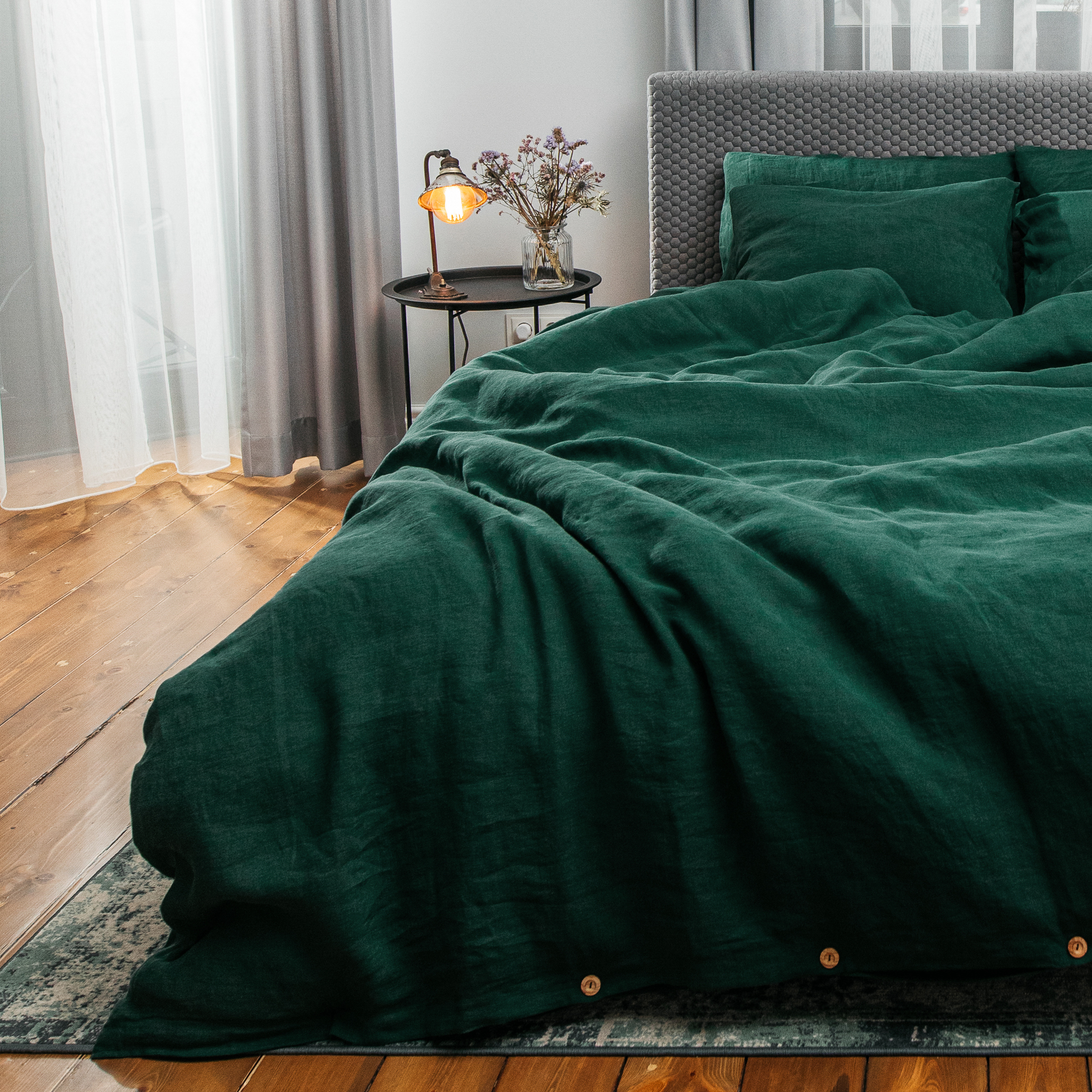 Emerald green linen bedding in luxury hotel setting