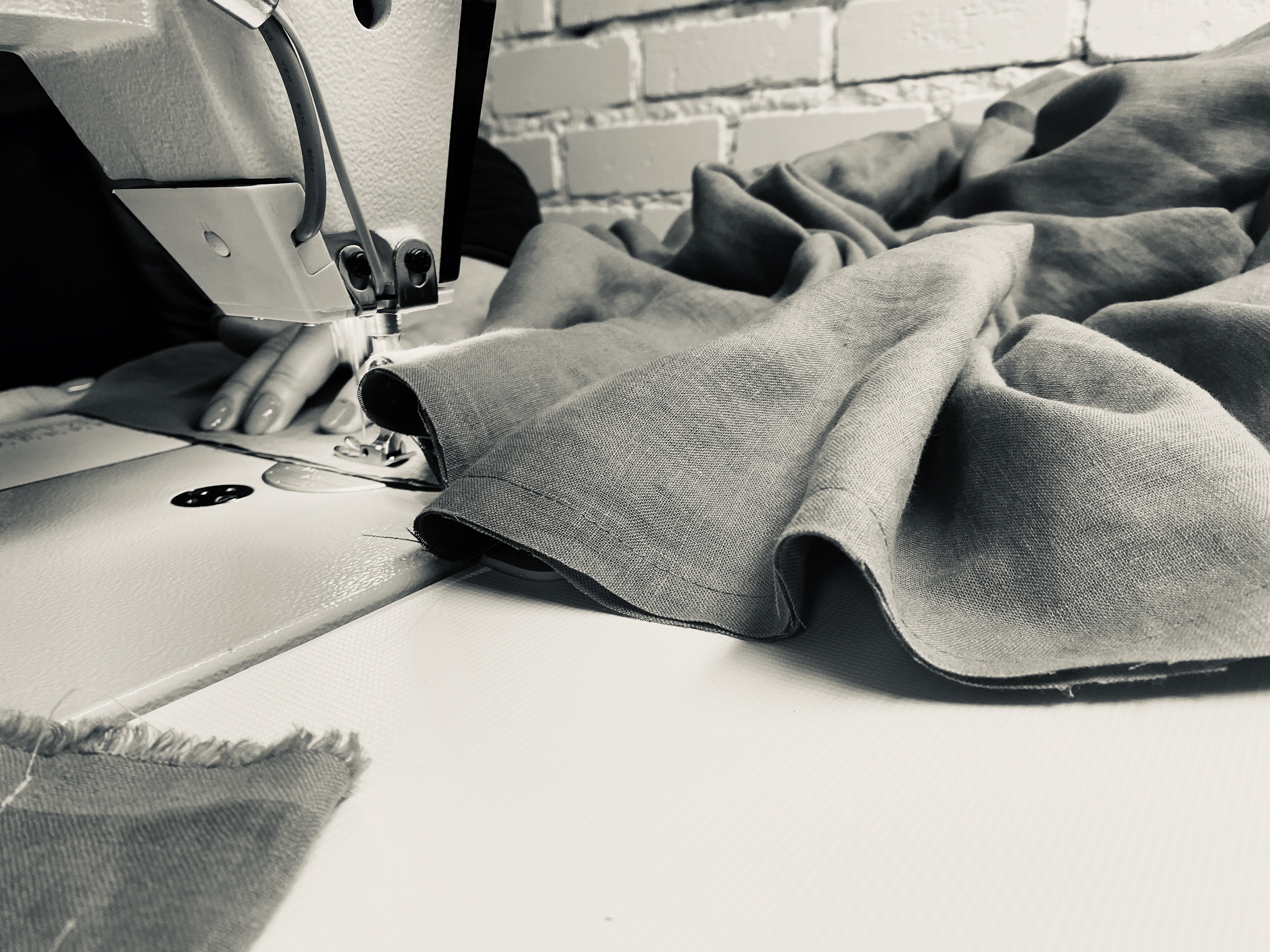 Handcrafting linen textiles in our Lithuanian studio - sewing machine working on natural linen fabric
